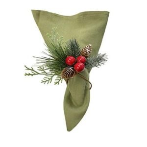 Green napkin with pine cones, berries, and greenery as decoration