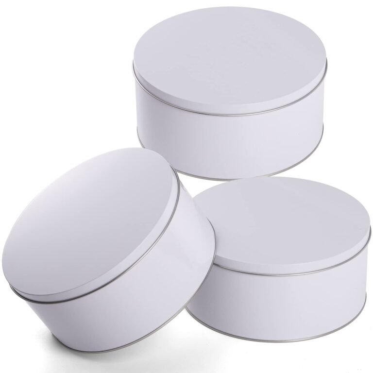 Three white round tins with silver rims, arranged on a white background