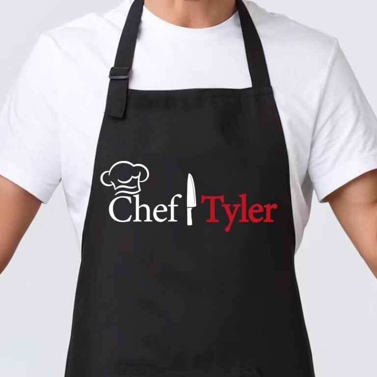 Man wearing a black apron with "Chef Tyler" and a chef hat logo