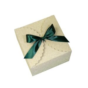 Glittery gift box with a green satin bow on a white background