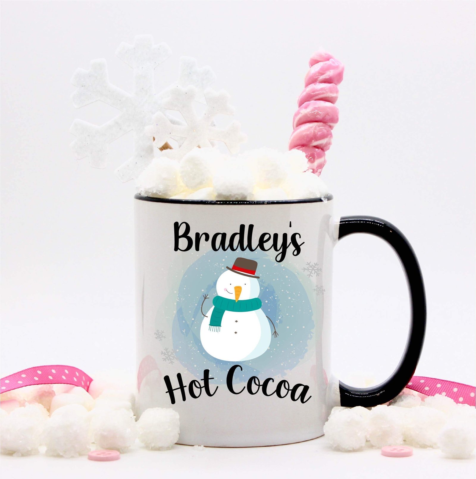 Hot cocoa mug with snowman design, marshmallows, snowflake, and pink candy cane