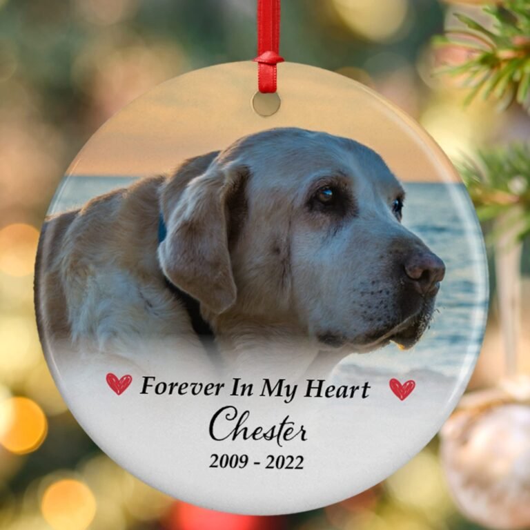 Ornament with a photo of a dog, memorial text, and red ribbon