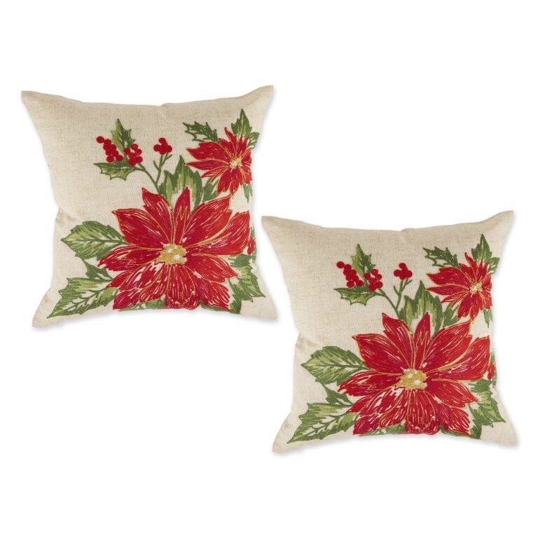 Two decorative pillows with embroidered red poinsettias and holly