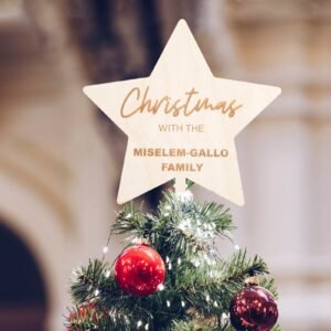 Christmas tree with star topper, red ornaments, and family name
