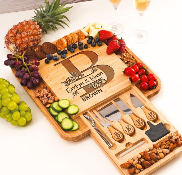 Wooden charcuterie board with fruit, cheese, nuts, and personalized engraving