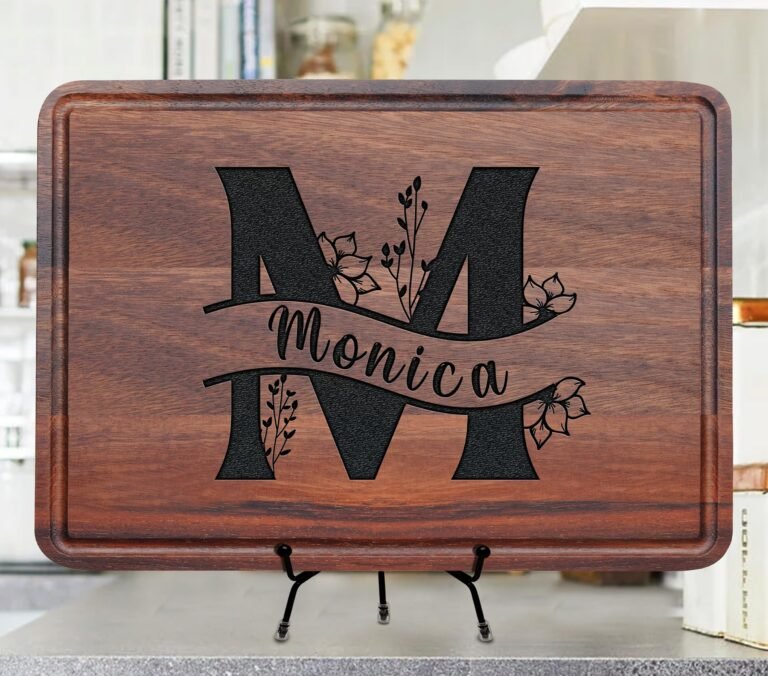 Wooden cutting board with engraved letter "M" and the name "Monica"
